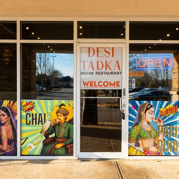 Vibrant Desi Tadka Indian Restaurant exterior with pop-art window graphics and a welcoming 'OPEN' sign.